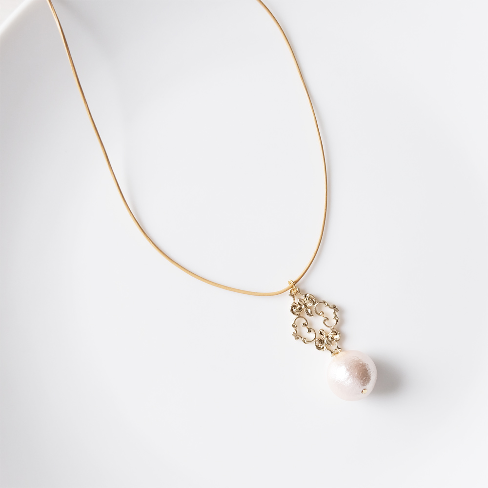 ボリュームあるコットンパールとメタルパーツをセットしたレザーネックレスの画像