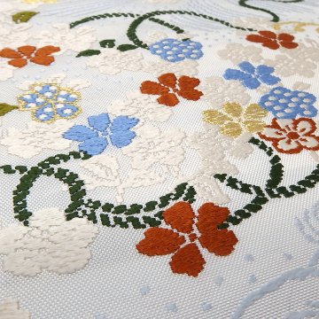 ＜お仕立て代込＞勝山さと子 「流水花束紋」 九寸名古屋帯 桜草木 / 白・灰水色と橙に金糸 の画像